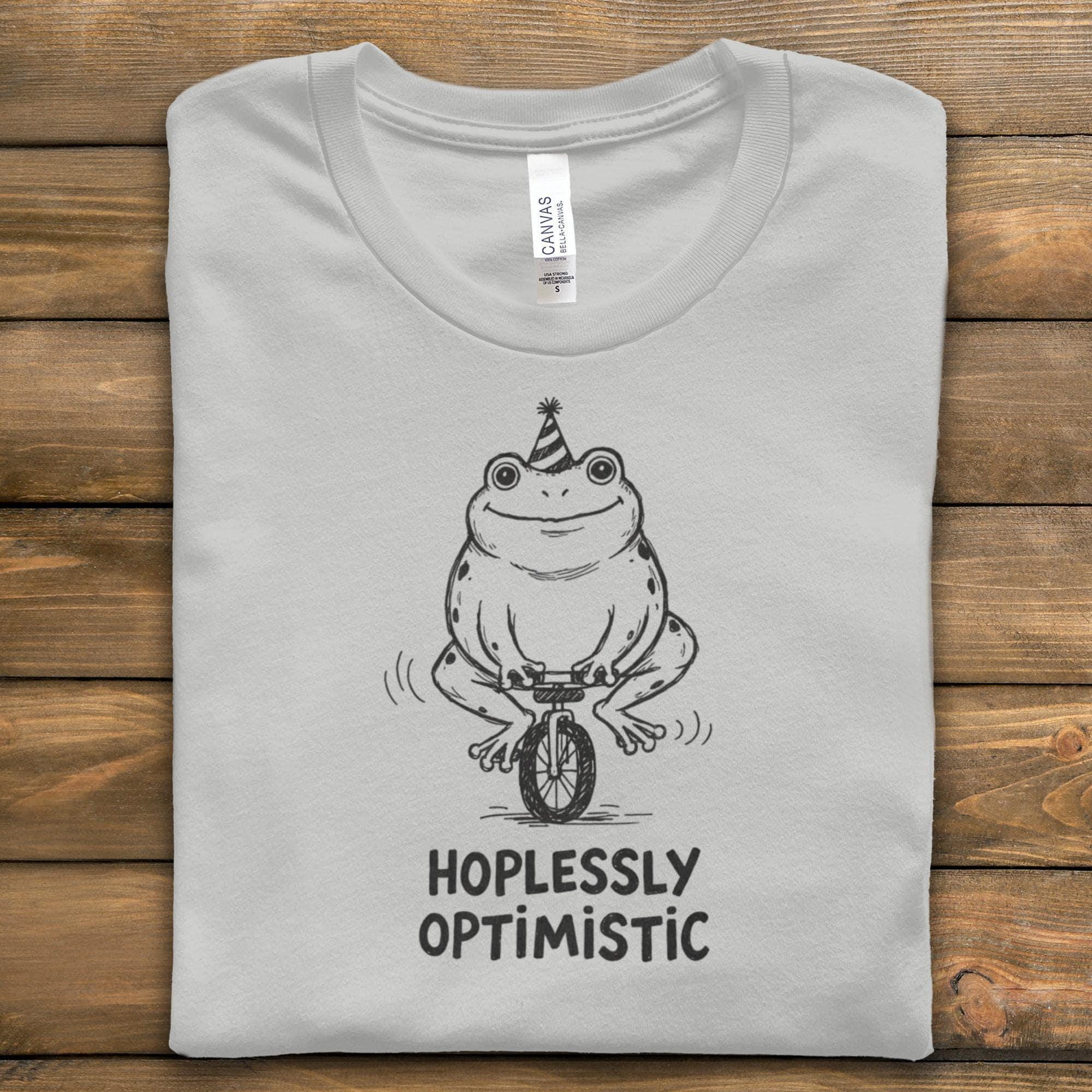 Funny Hopelessly Optimistic Frog Shirt, Unicycle Bicycle T-shirt, Cute Frog Tee, Whimsical Graphic Tee, Unique Funny Shirt Gift