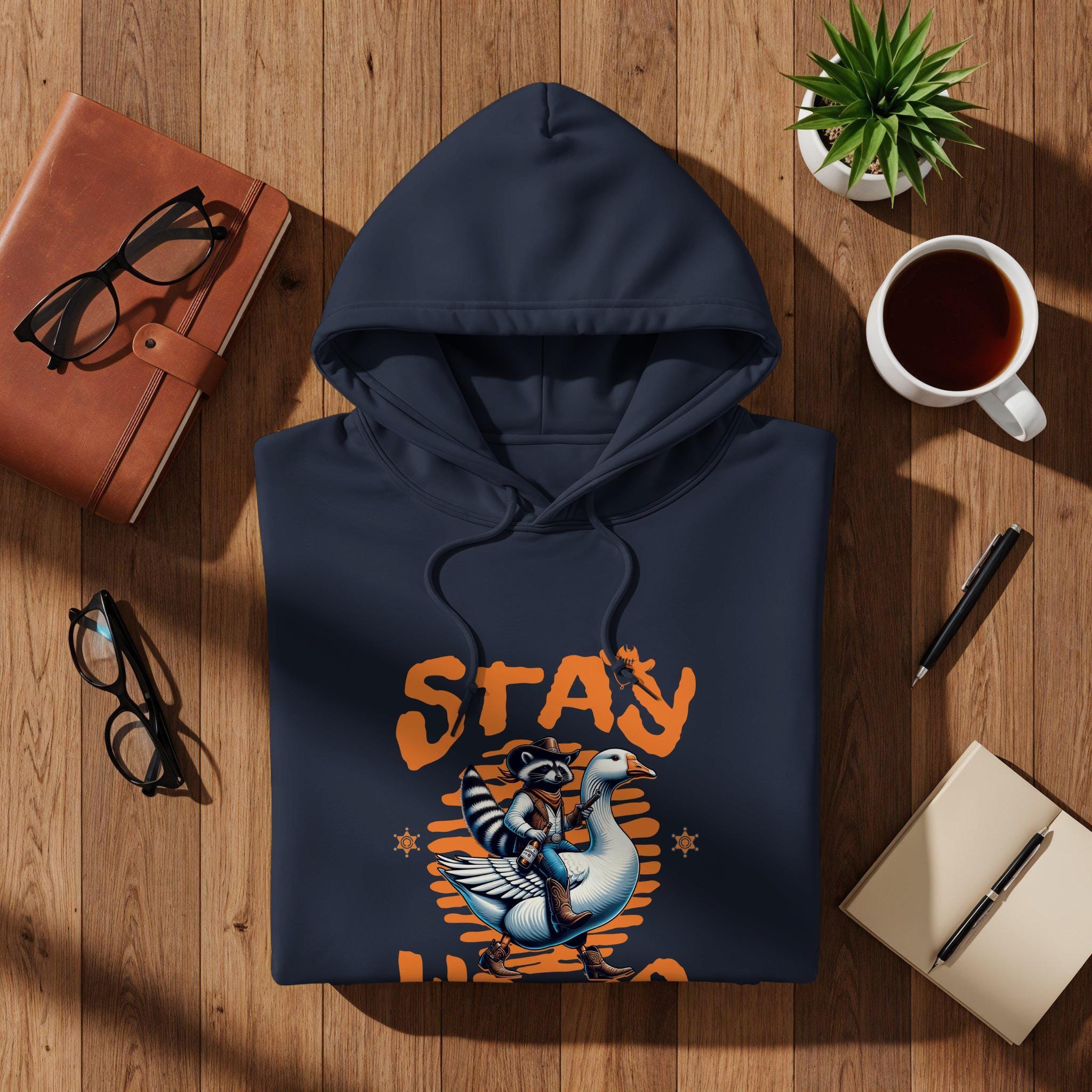 Stay Weird Hoodie, Funny Raccoon Riding Goose Sweatshirt, Cool Novelty Graphic Pullover, Comfy Casual Wear, Unique Gift Idea